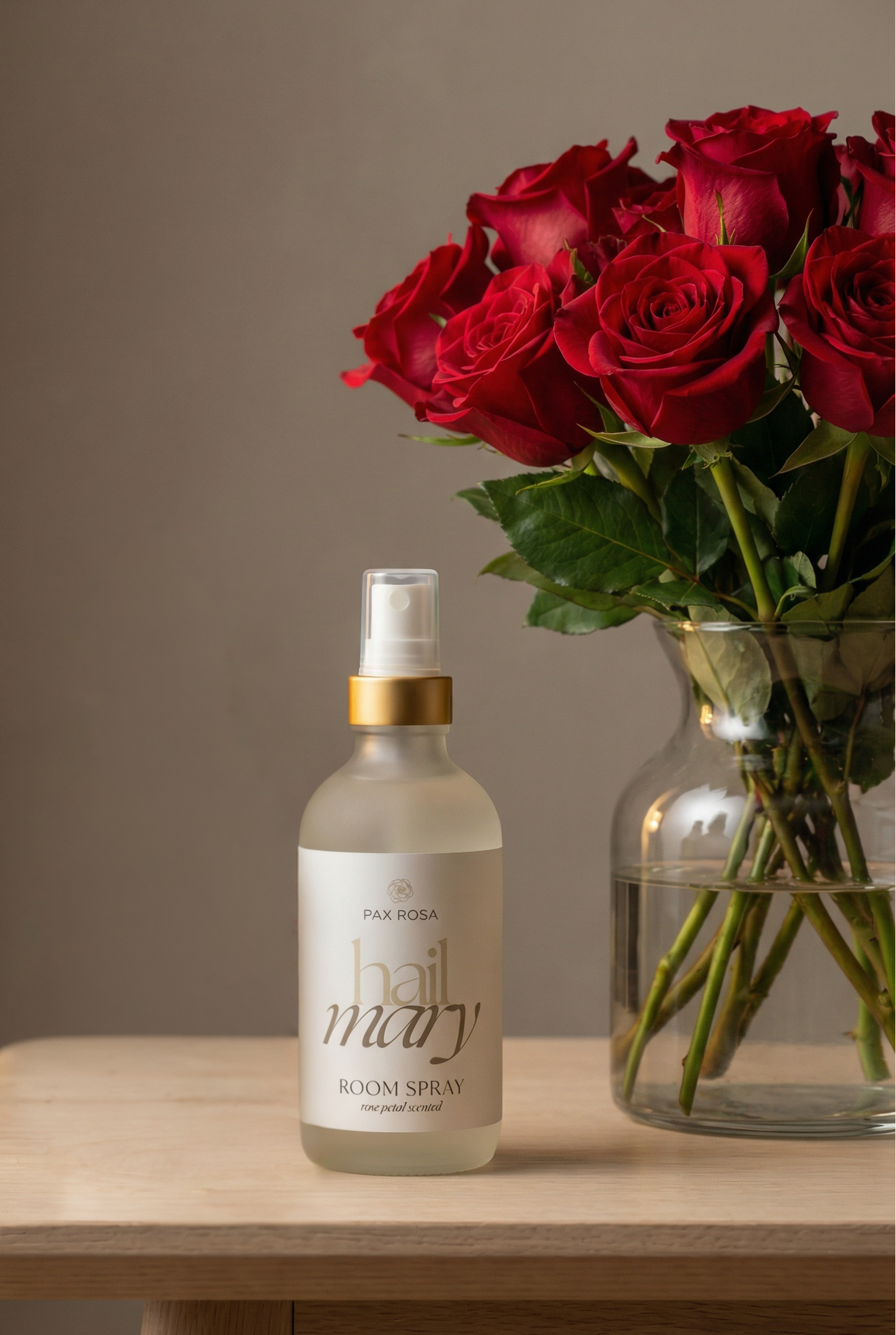 room spray label as "hail mary" with a vase of roses on a table