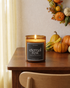 amber color candle with black label that says eternal rest"
