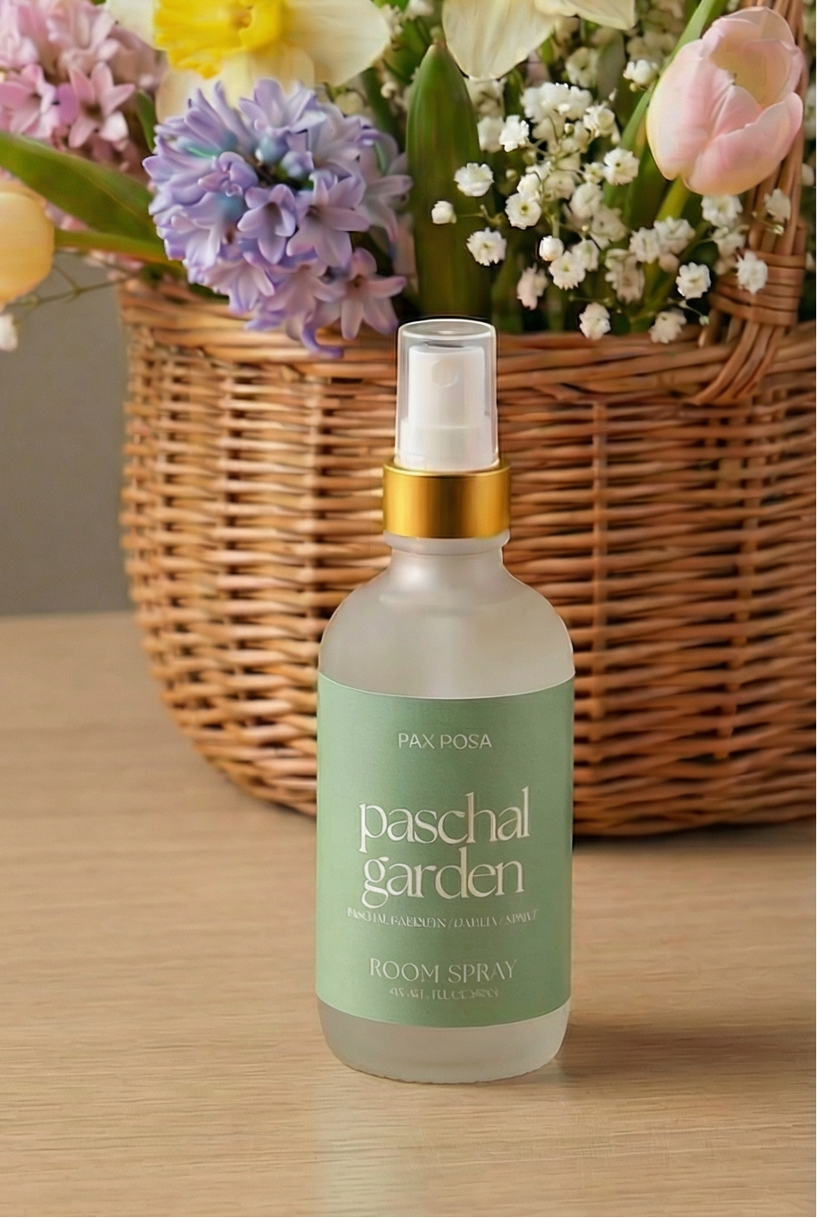 bottle with words written "paschal garden" on a wooden table.