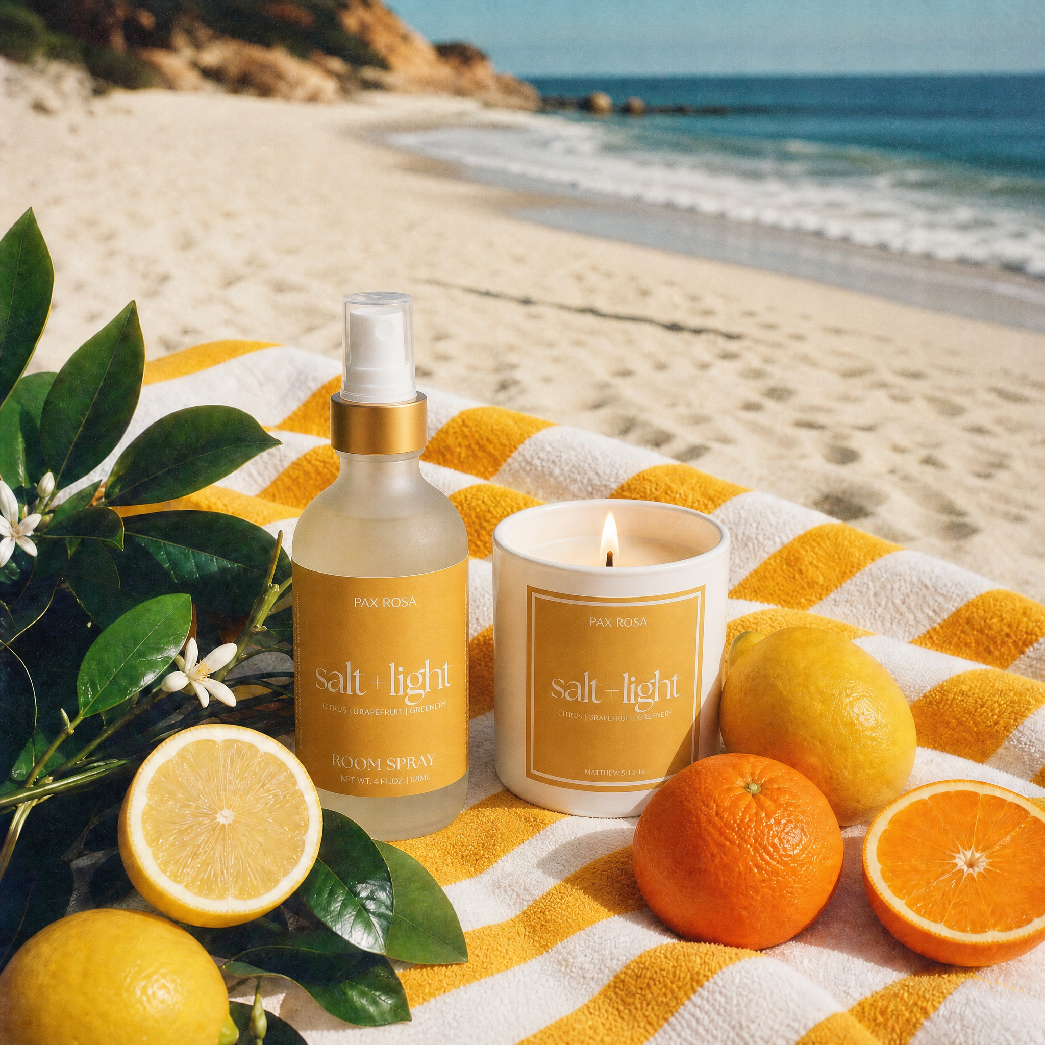 Salt &amp; Light products on a beach with lemons and oranges