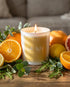 white candle with words "salt and light" on a table with citrus and greenery